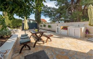 a patio with a table and chairs and a kitchen at 3 Bedroom Beach Front Home In Zdrelac in Ždrelac +36 photos