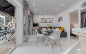 a dining room and living room with a table and chairs at 3 Bedroom Beach Front Home In Zdrelac in Ždrelac