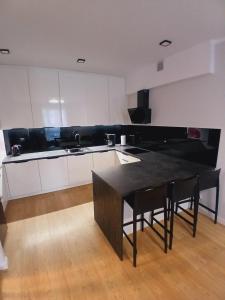 a kitchen with a table and chairs in a room at Słoneczny Apartament in Kłodzko