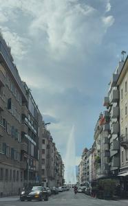 a city street with buildings and a rainbow in the sky at Studio moderne et chaleureux au coeur de Geneve - parfait pour courts sejours in Geneva