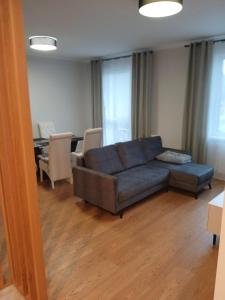 a living room with a couch and a table at Słoneczny Apartament in Kłodzko