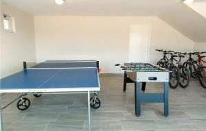 a ping pong table in a room with bikes at Luxurious Home In Vrsi in Vrsi