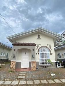 a small white house with a white door at Lady Liberty Residence in Panglao