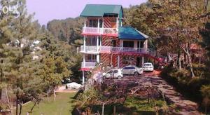 a house with cars parked in front of it at BHURBAN VIEW Apartments Murree in Murree +21 photos