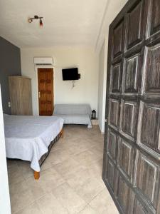 a bedroom with a bed and a sliding door at AtESI HOUSE-CHORTO in Chorto