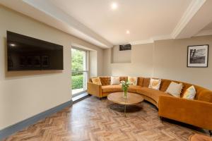a living room with a couch and a table at The Library Suite in Marske