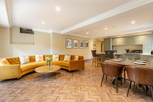 a living room with a couch and a table at The Library Suite in Marske
