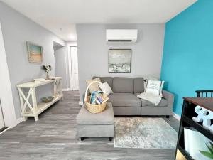 a living room with a couch and a table at Sunset Dream Minutes from the Beach - Unit 8 in Fort Walton Beach