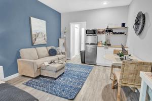 a living room with a couch and a kitchen at Anchor Ahoy Beach Getaway - Unit 6 in Fort Walton Beach +8 photos