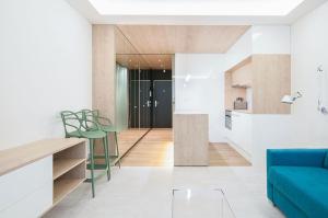 a kitchen and living room with a blue couch at White apartment in Playa del Carmen