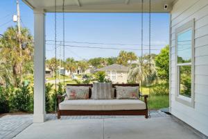 a swing on the porch of a house at Grand Retreat II: 4BR, 5BA, sleeps 15 Private pool Your perfect escape! in Sunnyside