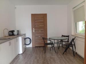 a kitchen and dining room with a table and chairs at Stogi Dom in Gdańsk