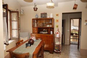 a dining room with a table and a wooden cabinet at Casa Pracol in Combai
