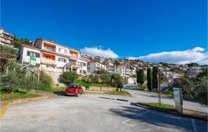 un coche rojo estacionado al lado de una calle en Gorgeous Apartment In Rabac With Wi-Fi, en Rabac 14 fotos más