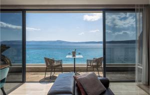 a living room with a couch and a view of the ocean at Stunning Apartment In Crikvenica in Crikvenica
