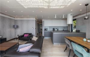 a kitchen and living room with a couch and a table at Stunning Apartment In Crikvenica in Crikvenica