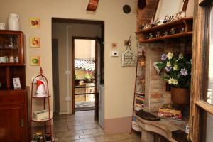 a room with a brick wall and a door with a shelf at Casa Pracol in Combai