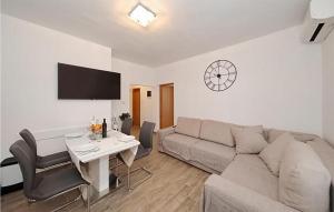 a living room with a couch and a table at 2 Bedroom Nice Apartment In Pasman in Pašman