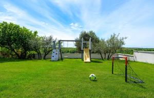 a playground with a soccer ball on the grass at Gorgeous Home In Buje With Wifi in Veli Vrh +46 photos