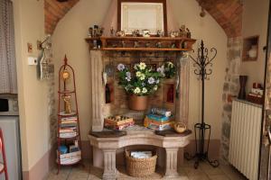 a fireplace in a living room with flowers on it at Casa Pracol in Combai +30 photos