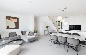 a white living room with a table and chairs at Gorgeous Home In Dramalj in Dramalj