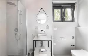 a white bathroom with a sink and a mirror at Gorgeous Home In Dramalj in Dramalj +24 photos