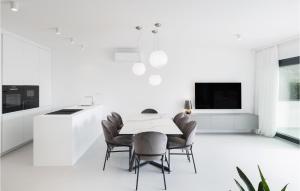 a white dining room with a table and chairs at Gorgeous Home In Dramalj in Dramalj