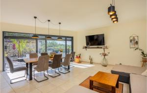 a dining room and living room with a table and chairs at Cozy Home In Grizane-Belgrad in Grižane