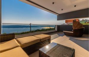 a living room with a couch and a view of the ocean at Awesome Home In Crikvenica With Sauna in Crikvenica
