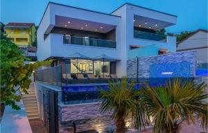 a house with a swimming pool at dusk at Awesome Home In Crikvenica With Sauna in Crikvenica