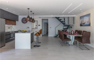 a kitchen and living room with a table and chairs at Awesome Home In Crikvenica With Sauna in Crikvenica