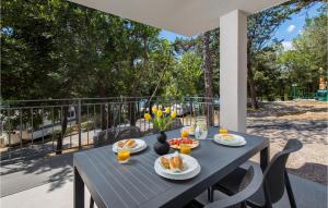 a black table with food and flowers on a balcony at Stunning Home In Kraljevica With Wifi in Kraljevica +27 photos
