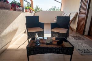 two chairs and a coffee table on a balcony at B&B Ulivo del Duca in Fermignano +16 photos
