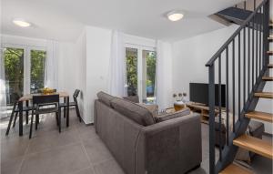 a living room with a couch and a table at Stunning Home In Kraljevica With Wifi in Kraljevica