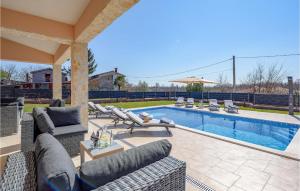 a backyard with a swimming pool with chairs at Beautiful Home In Nedescina in Nedeščina +37 photos
