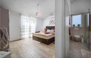 a bedroom with a bed and a bathroom at Beautiful Home In Nedescina in Nedeščina