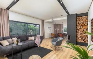 a living room with a gray couch and a table at Stunning Home In Pula in Pula