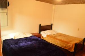 Postel nebo postele na pokoji v ubytování Hostal Juan Páramo