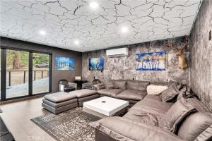 a living room with a couch and a table at Modern Mountain Luxury Soak, Stay, & Be Spoiled in Shaver Lake