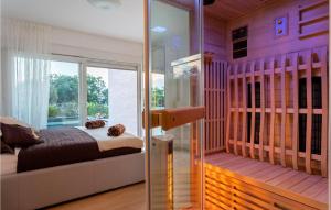a bedroom with a bed and a glass door at Cozy Home In Klimno With Wifi in Klimno
