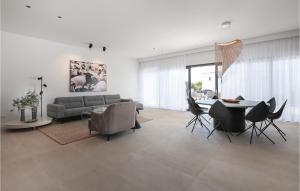 a living room with a couch and a table and chairs at Vila Del Sol in Lun
