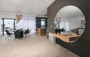 a dining room and living room with a mirror at Vila Del Sol in Lun
