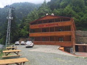 a building with a car parked in front of it at Cam Hotel & Restaurant 2 in Uzungöl