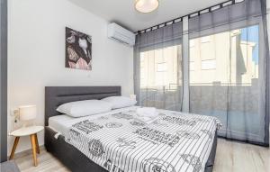a bedroom with a bed and a large window at Beautiful Home In Njivice With Wifi in Njivice