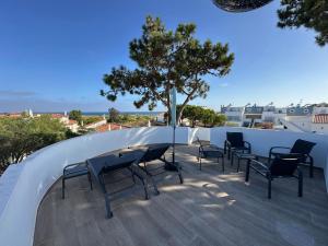 a patio with chairs and a table on a roof at Balsamaris in Manta Rota