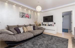 a living room with a couch and a flat screen tv at Lovely Home In Kolanjski Gajac With Wifi in Skunca
