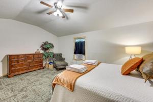 a bedroom with a bed and a ceiling fan at 5 Mi to Lake Ouachita Peaceful Cabin Retreat in Royal