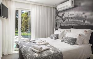 a bedroom with a large bed with towels on it at 8 Bedroom Gorgeous Home In Zadar in Zadar