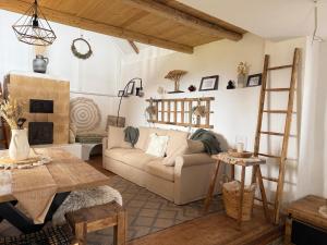 a living room with a couch and a table at Baglyashegy Vendégház in Sümeg