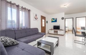 a living room with a couch and a table at Gorgeous Home In Rukavac With Kitchen in Rukavac